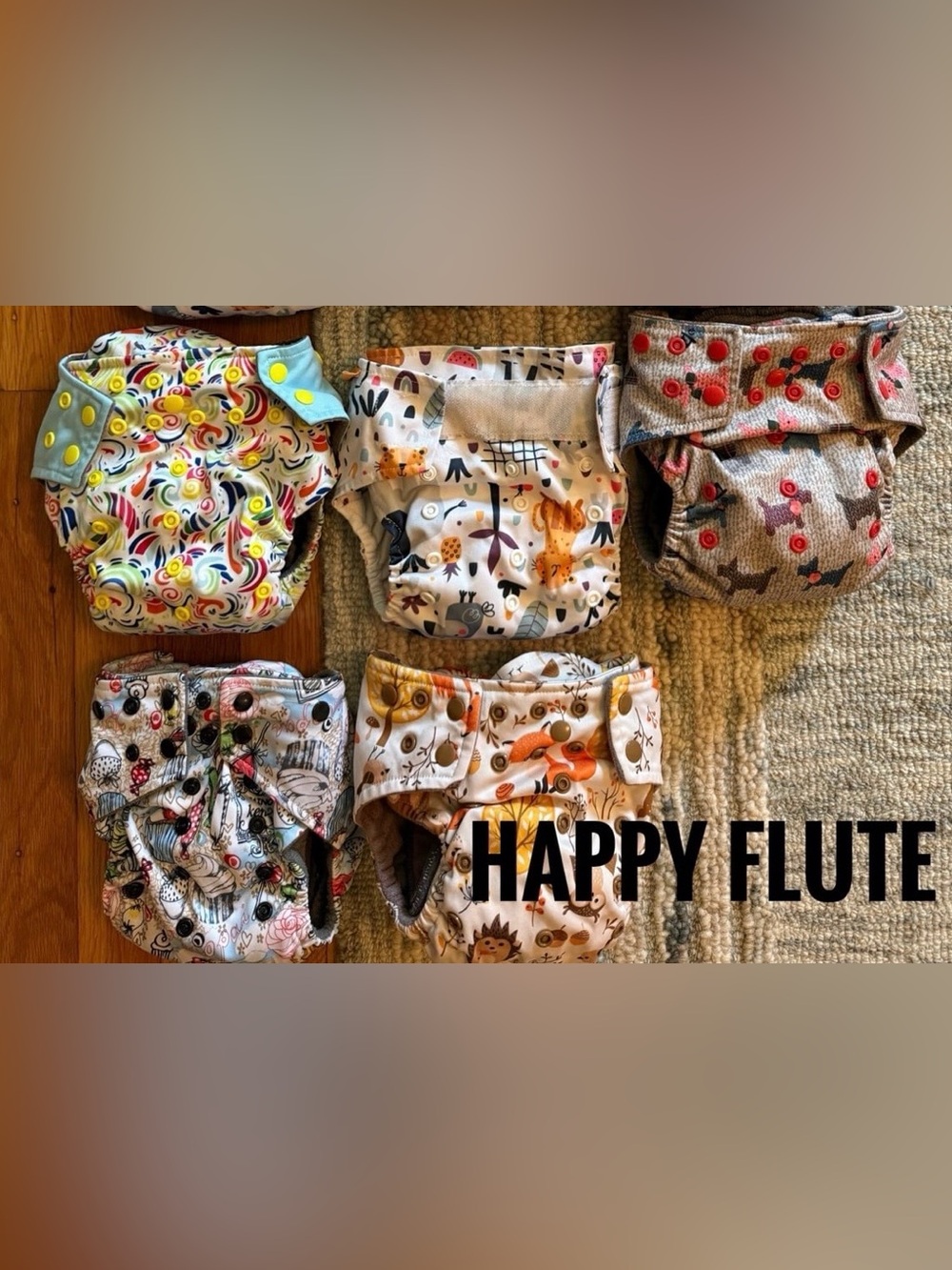 11 Happy Flute All in One cloth diapers.